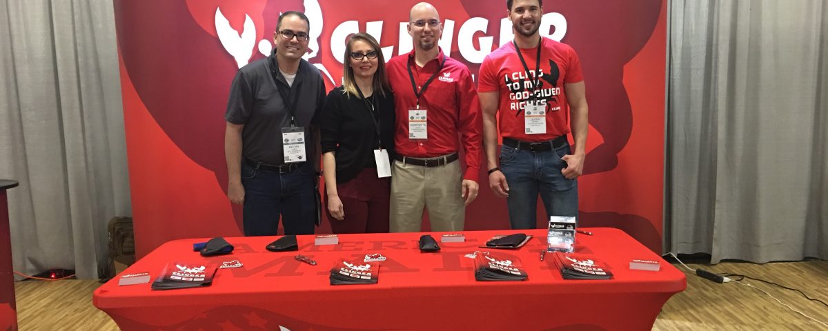 Melvin Torres (left) stands with the Clinger Holsters team at SHOT Show. Chris (middle right) and Sherry (middle left) Tedder operate their business out of Van Buren, Arkansas.
